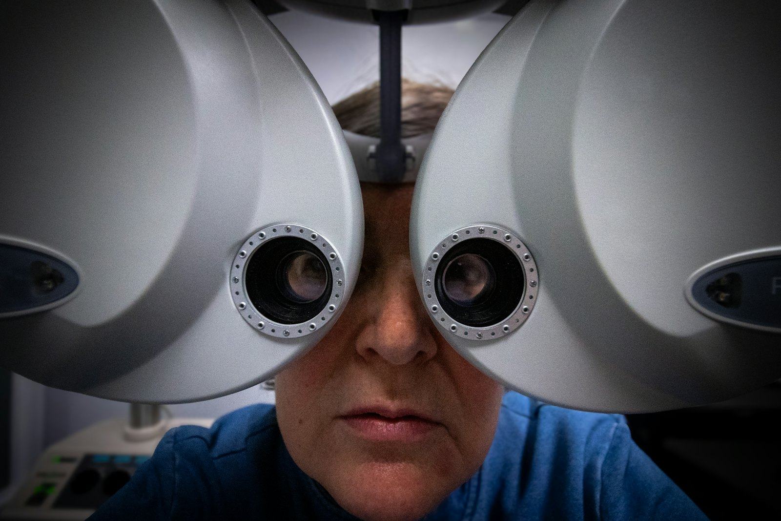 Patient having an eye exam with a phoropter at the optometrist