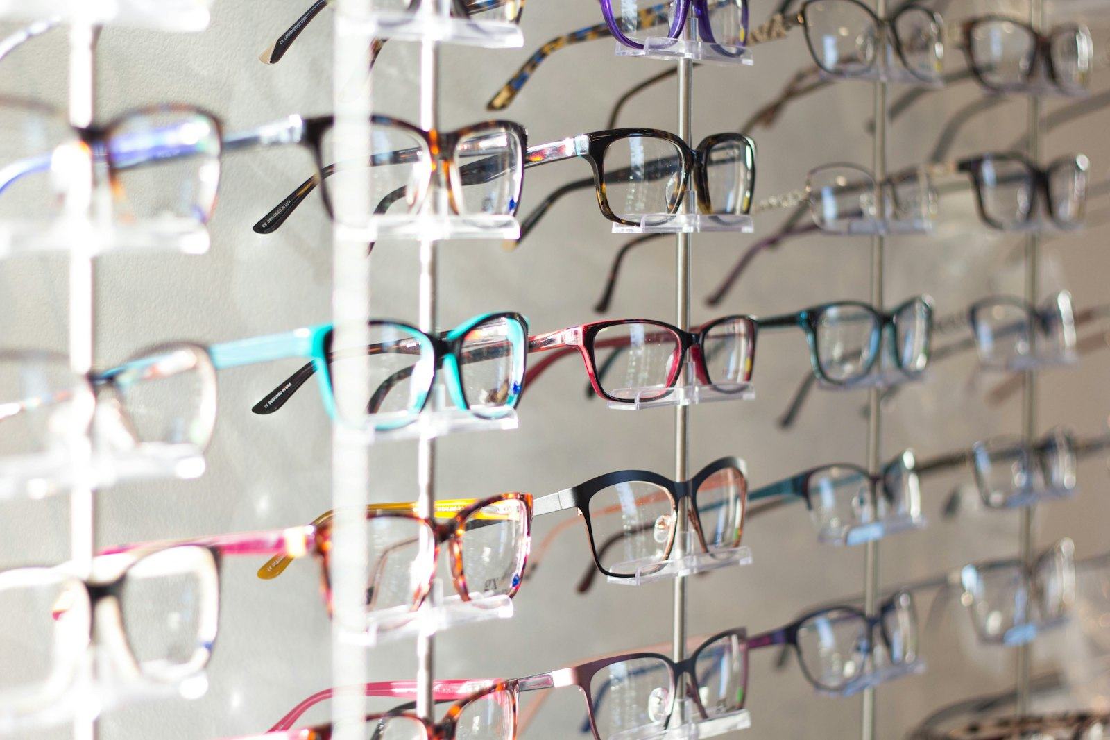 Wall display of colorful eyeglass frames at an optical shop